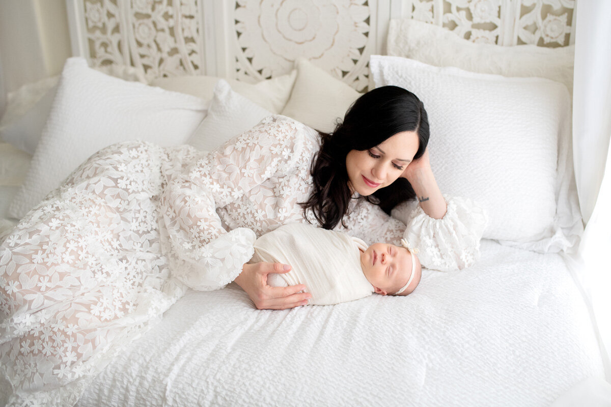 Newborn session of baby with mother wearing a dress