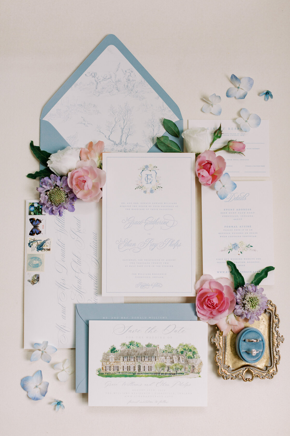 Custom wedding stationery with a crest and a watercolor depiction of the ceremony estate