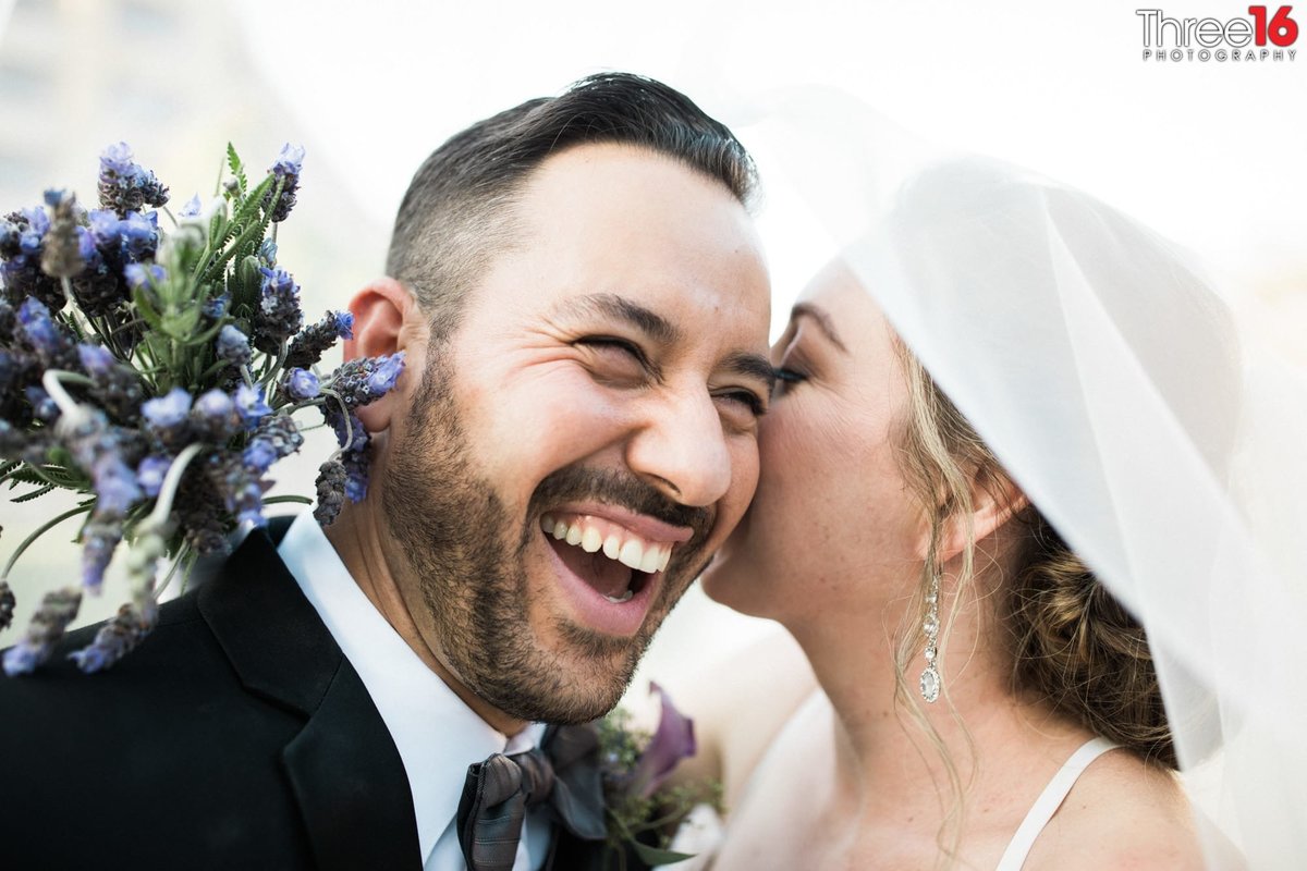 Bride whispers sweet nothing's into her Groom's ear