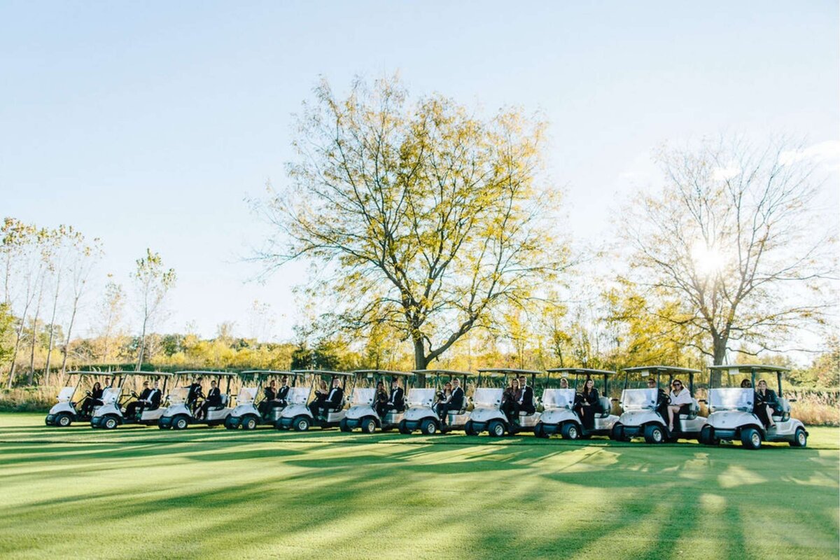 Wedding Party take Golf Cart Portraits during a Luxury Michigan Lakefront Golf Club Wedding.