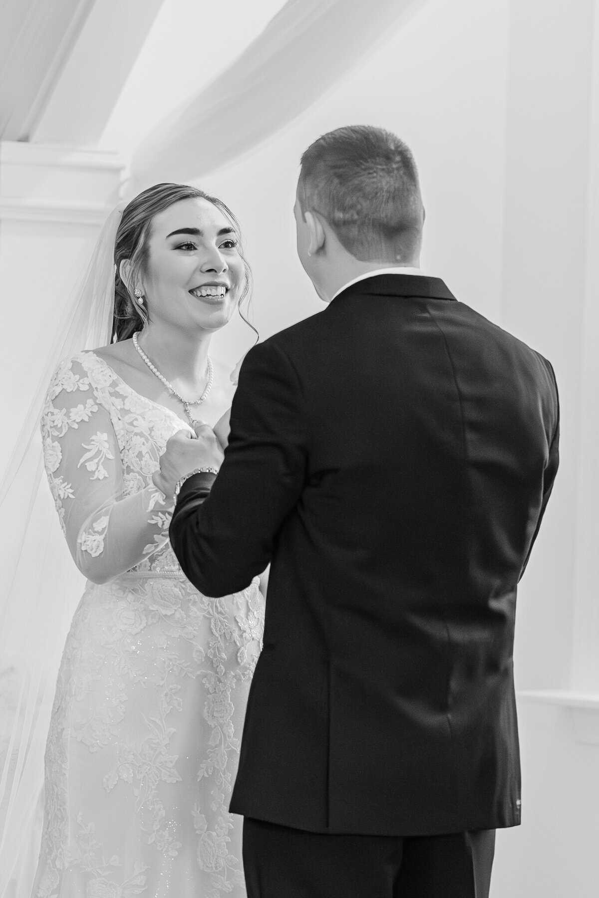 A couple exchanging vows at The Hudson Manor's wedding chapel by JoLynn Photography, a North Carolina wedding photographer