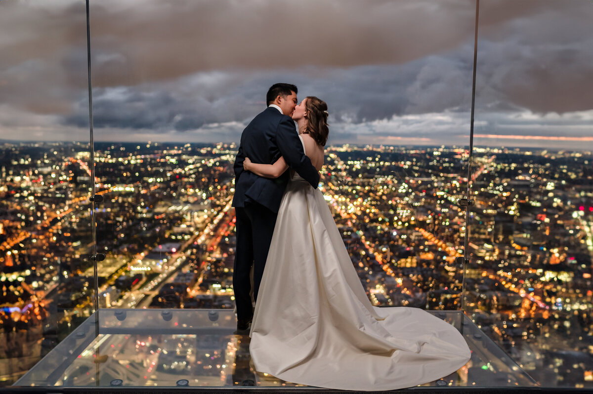 Bride an groom kiss on the Skydeck at Willis Tower