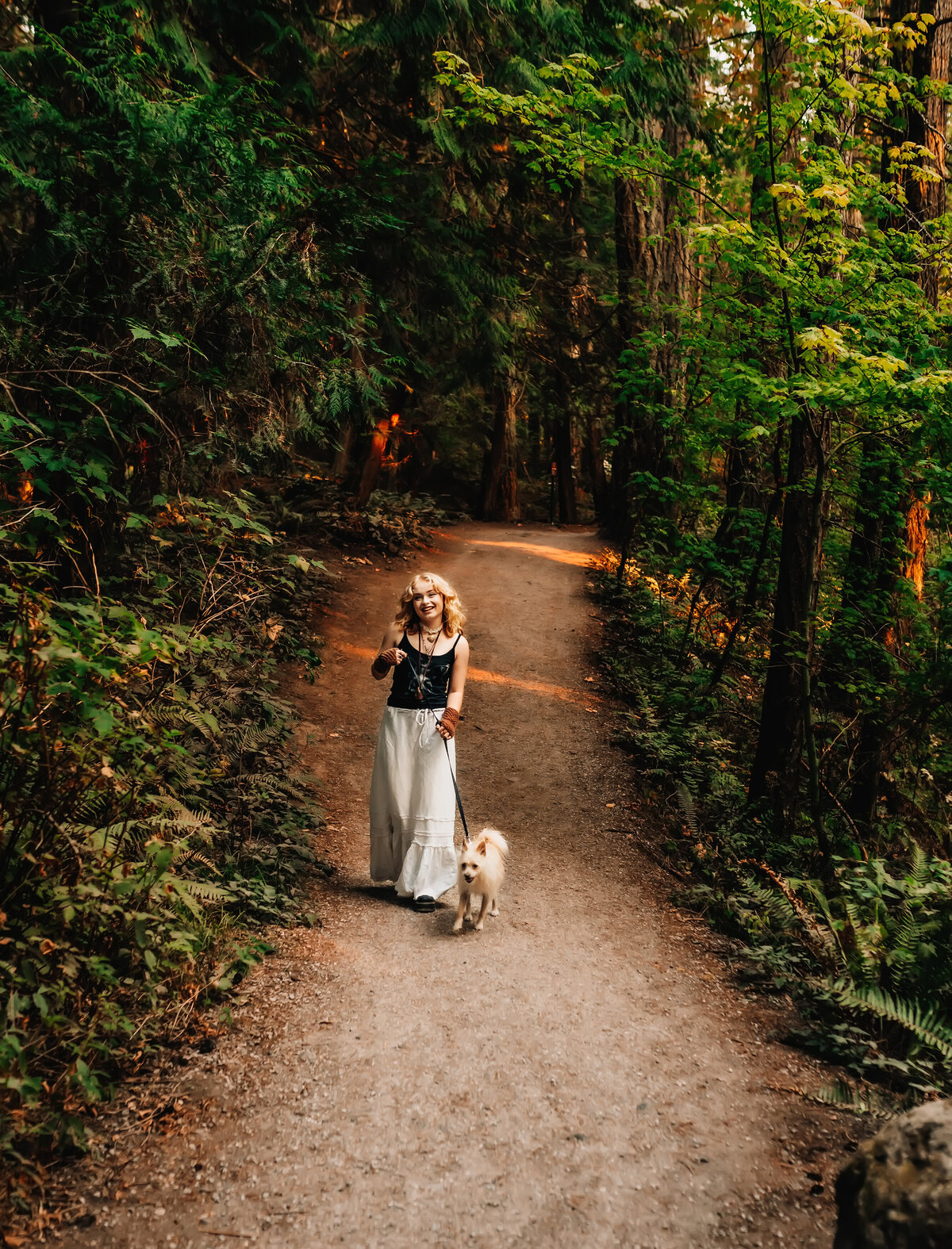 Girl walking dog in forest