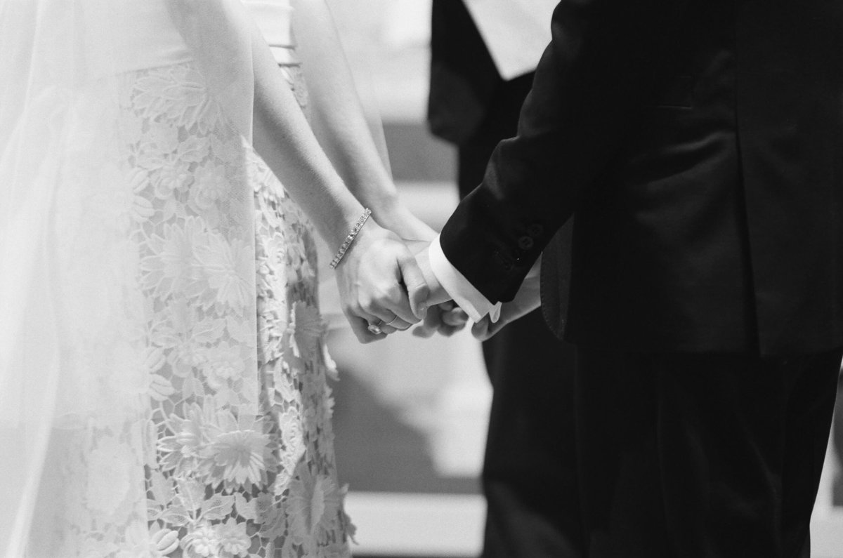 24-KTMerry-weddings-holding-hands-ceremony-black-white