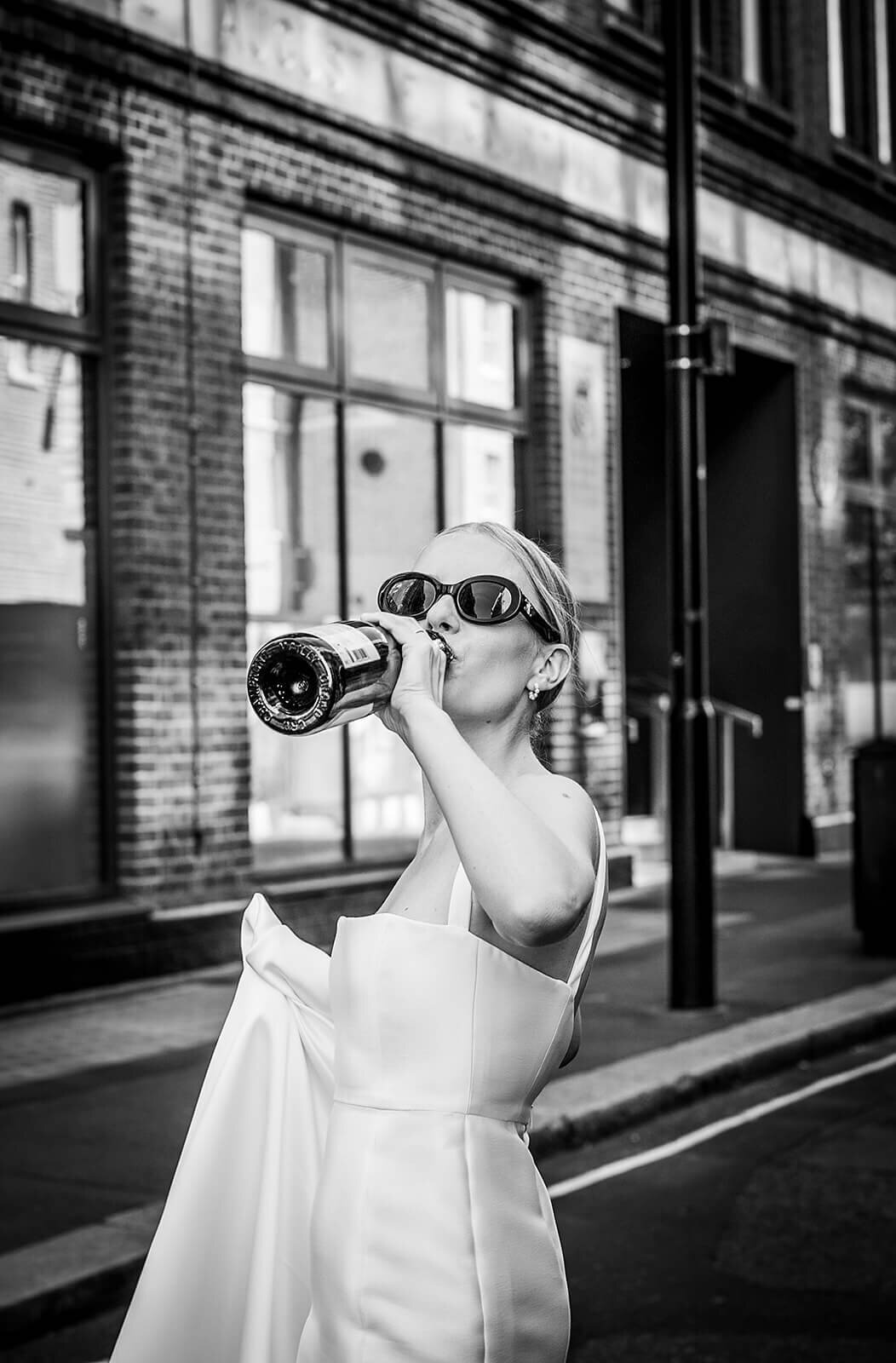 Bride drinking from bottle in Lomdon Street