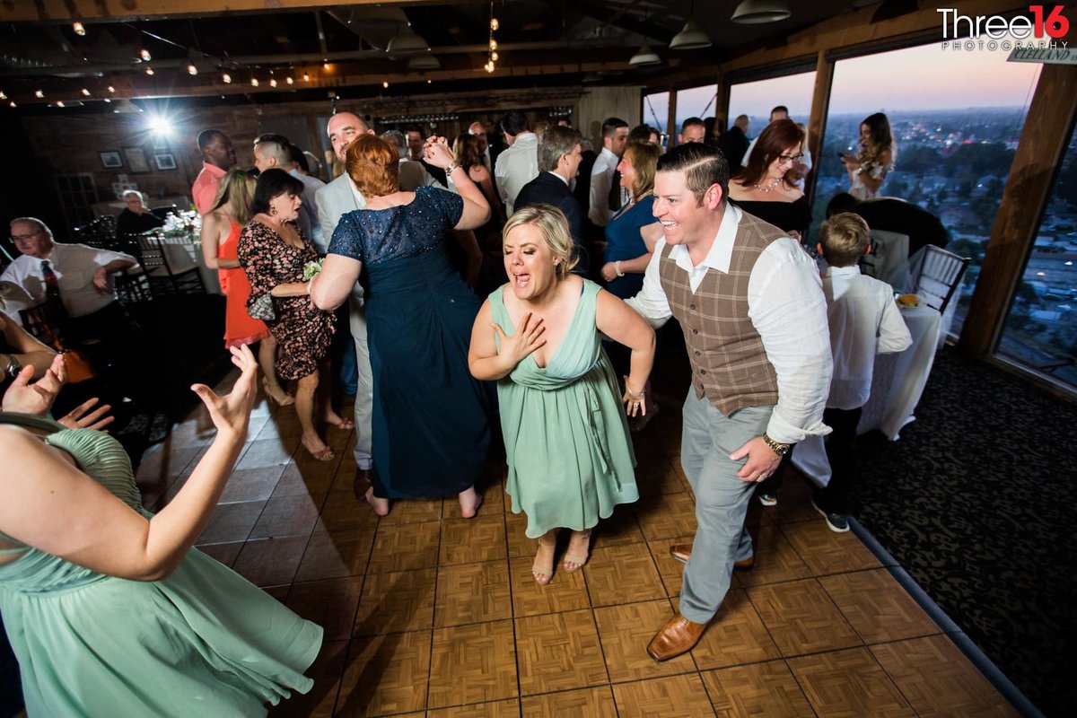 Bridal Party members sing and dance on the dancefloor