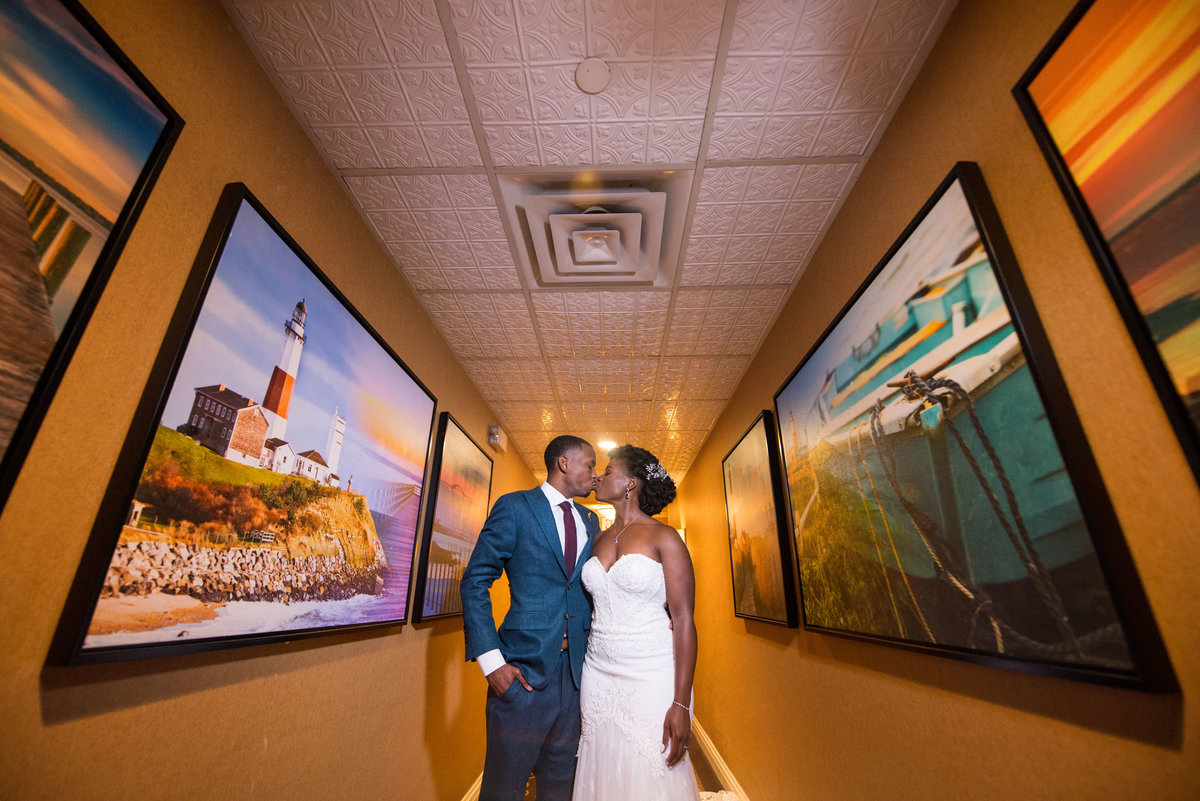Bride and groom kissing in the hallway at The Inn at Fox Hollow