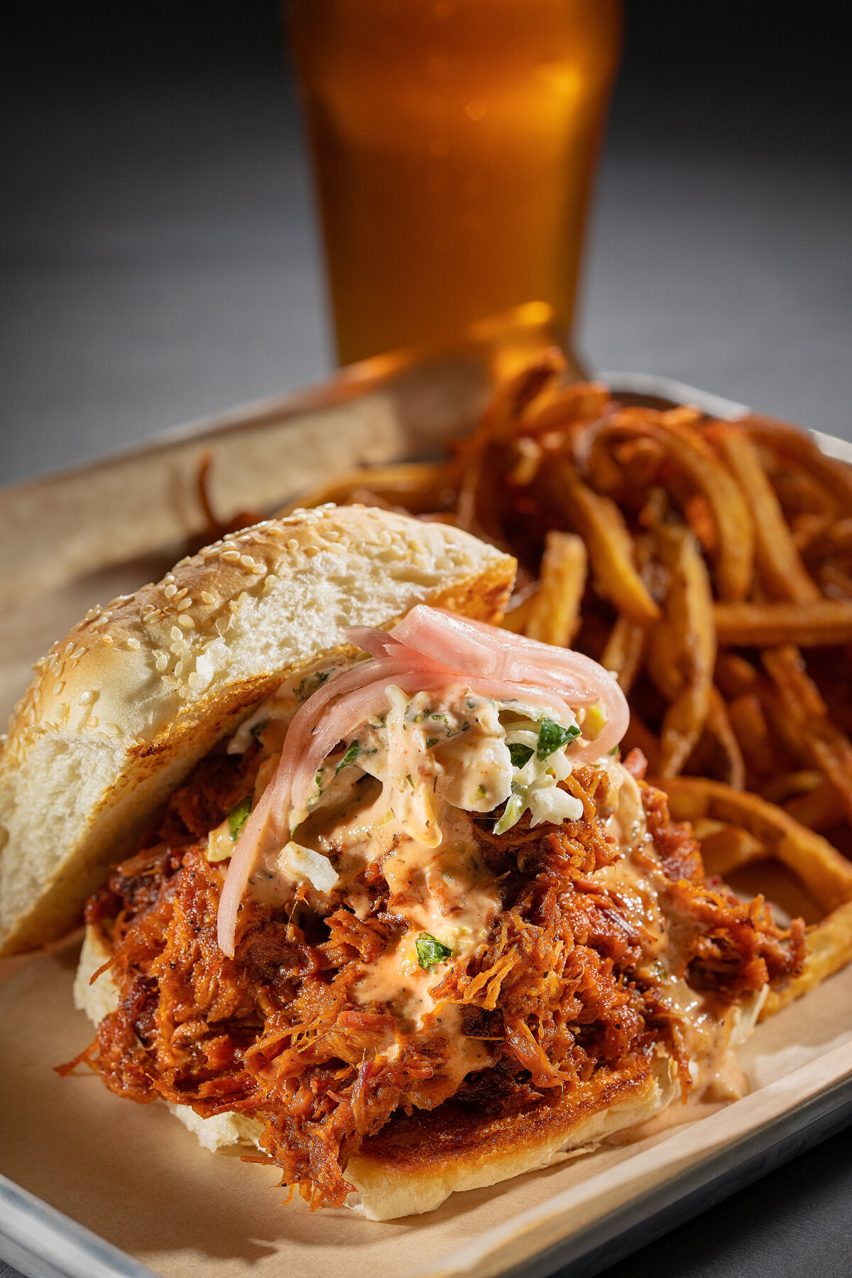 a pulled pork sandwich with fries