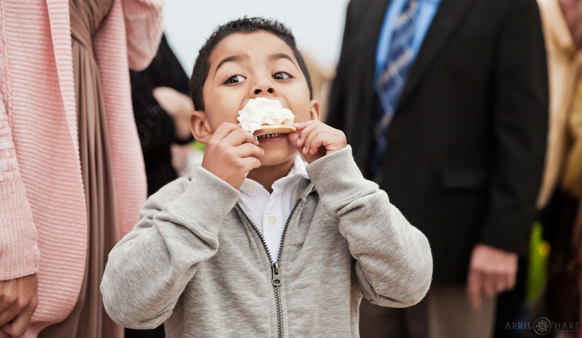 Funny Colorado Wedding Photography Boy Takes Huge Bite out of Dessert