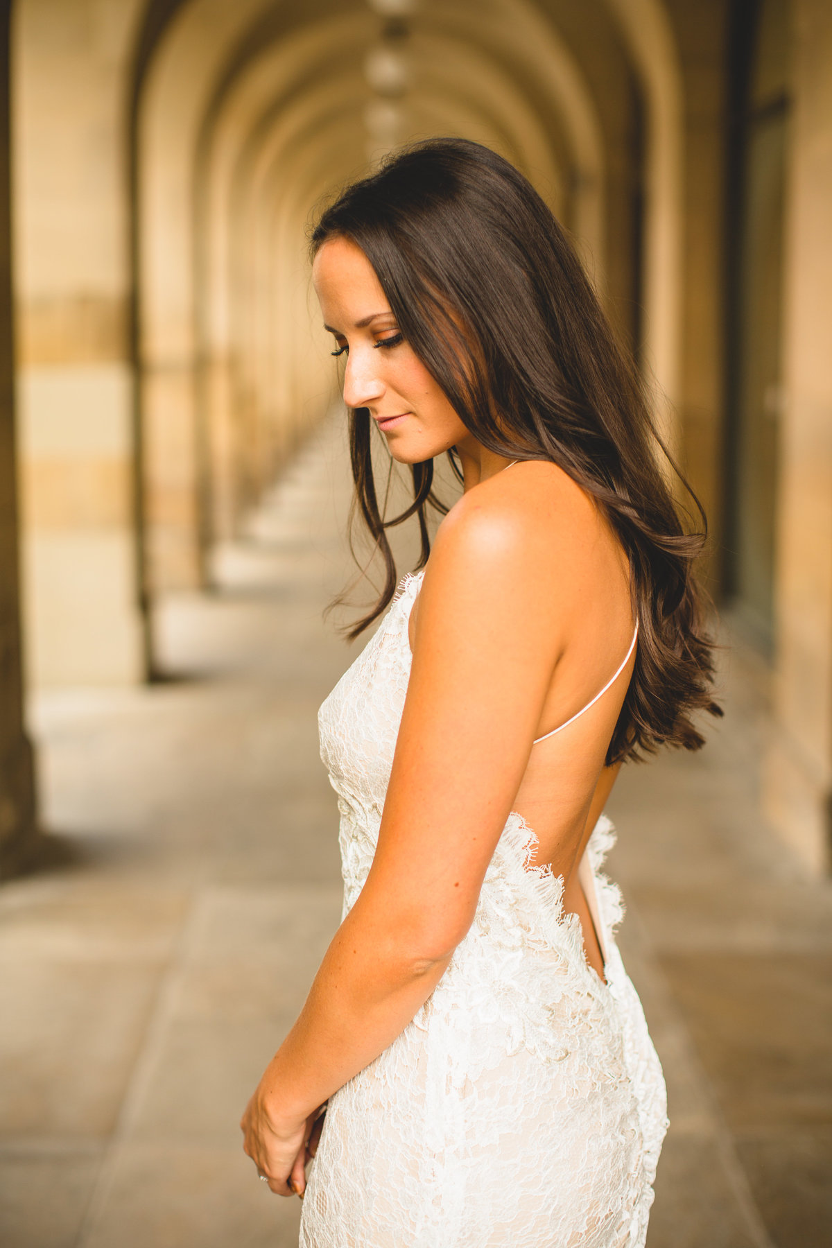 bride with lace dress under arches