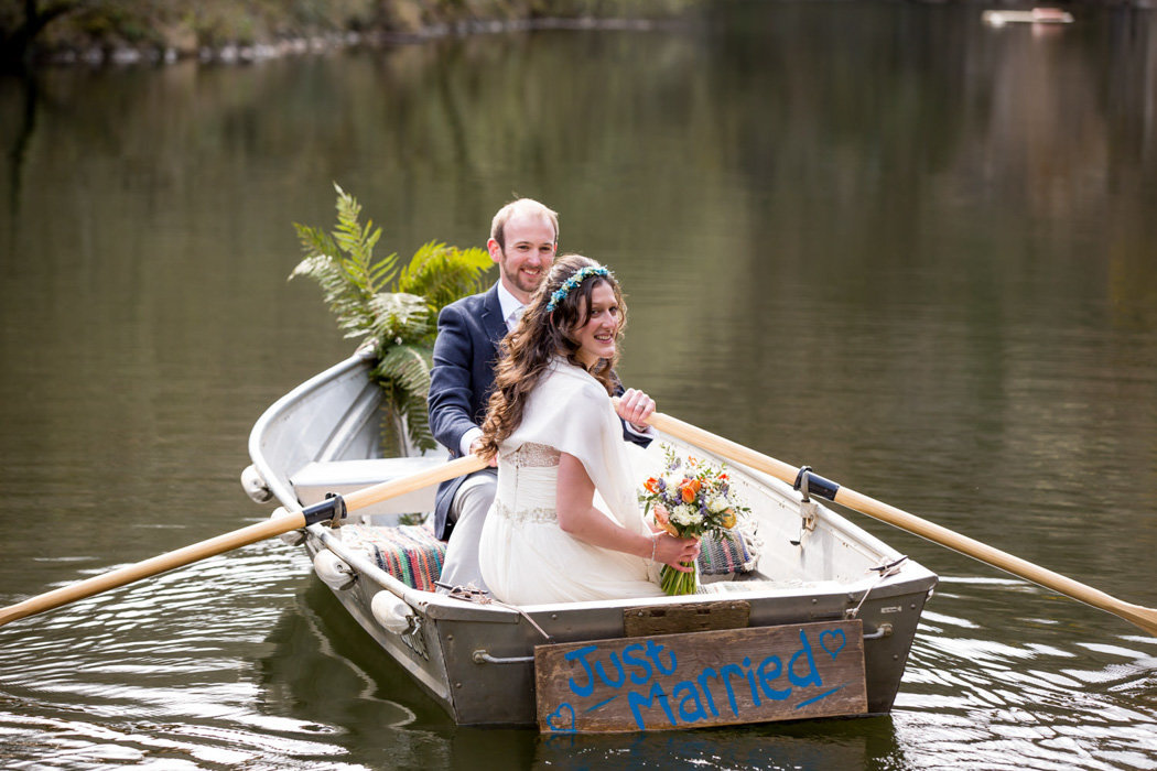 Bride and Groom in a boat at Cornish wedding
