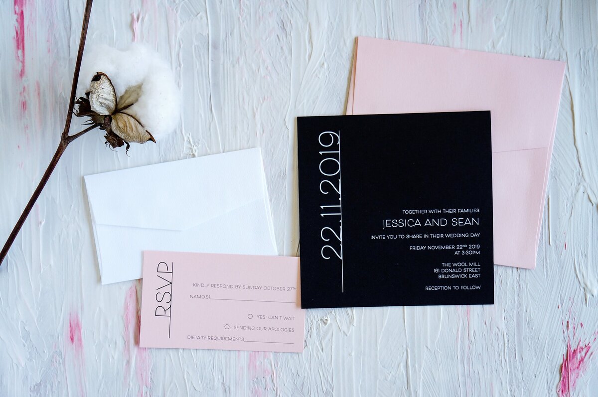 Pink and black wedding invitation with bold font