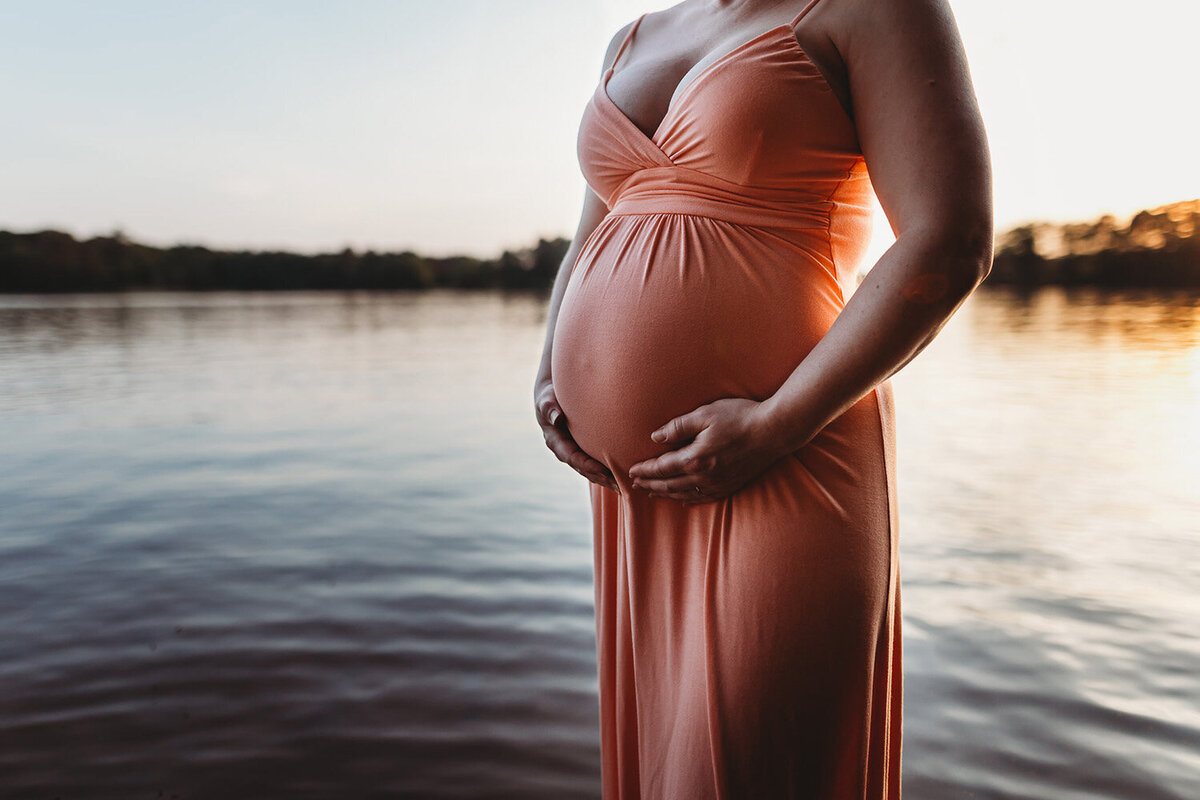 pregnant woman orange dress in water