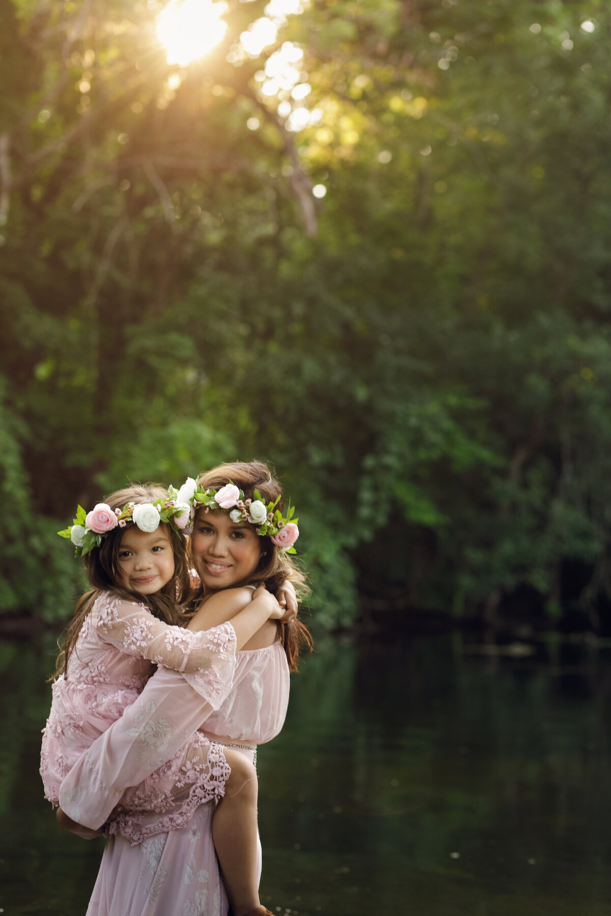 mom and daughter in pink dresses in park