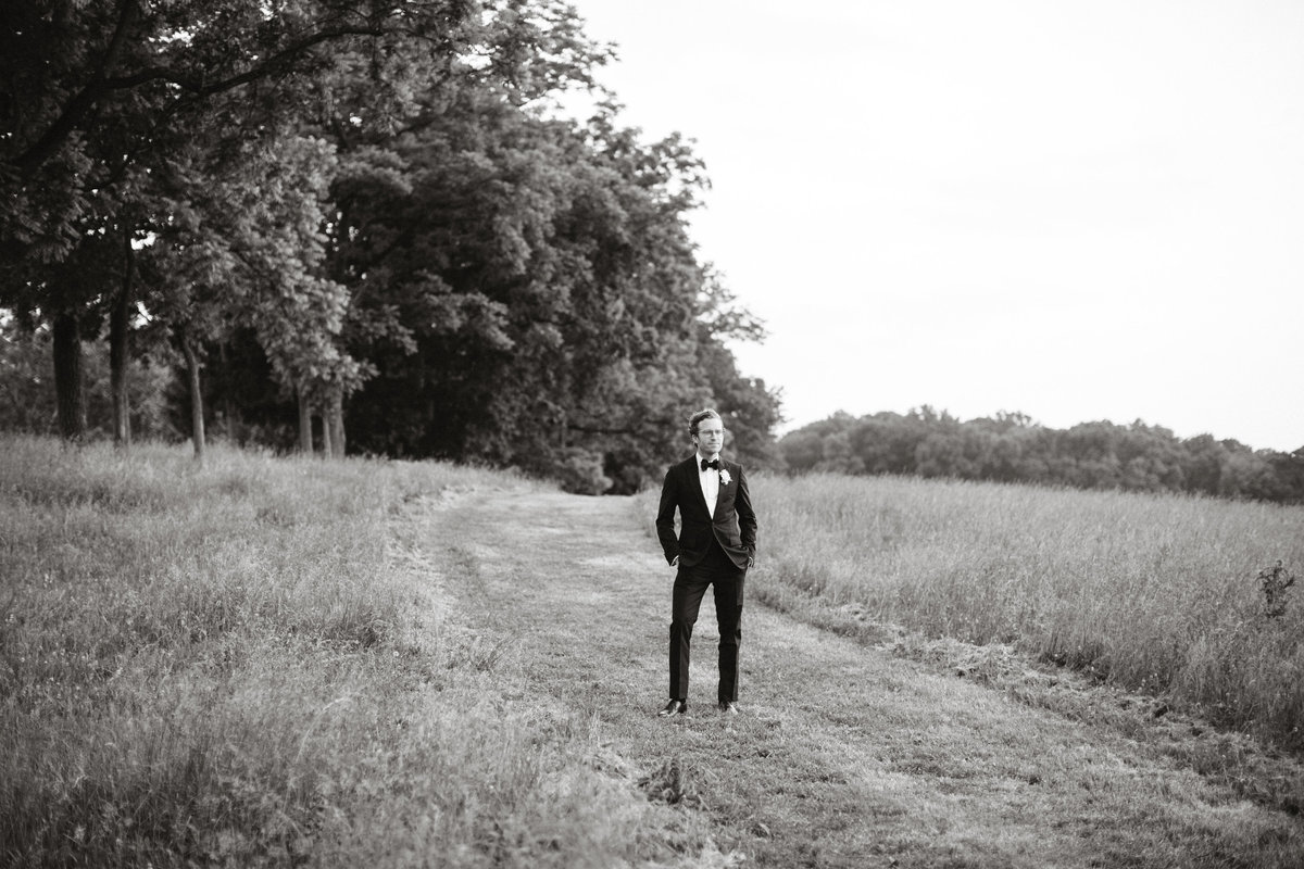 Groom photographed in the field on the family farm property in Phoenixville.