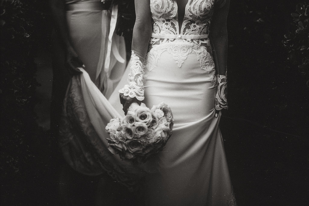 Wedding Photograph Of Woman Helping Bride With Her Dress Black And White Los Angeles