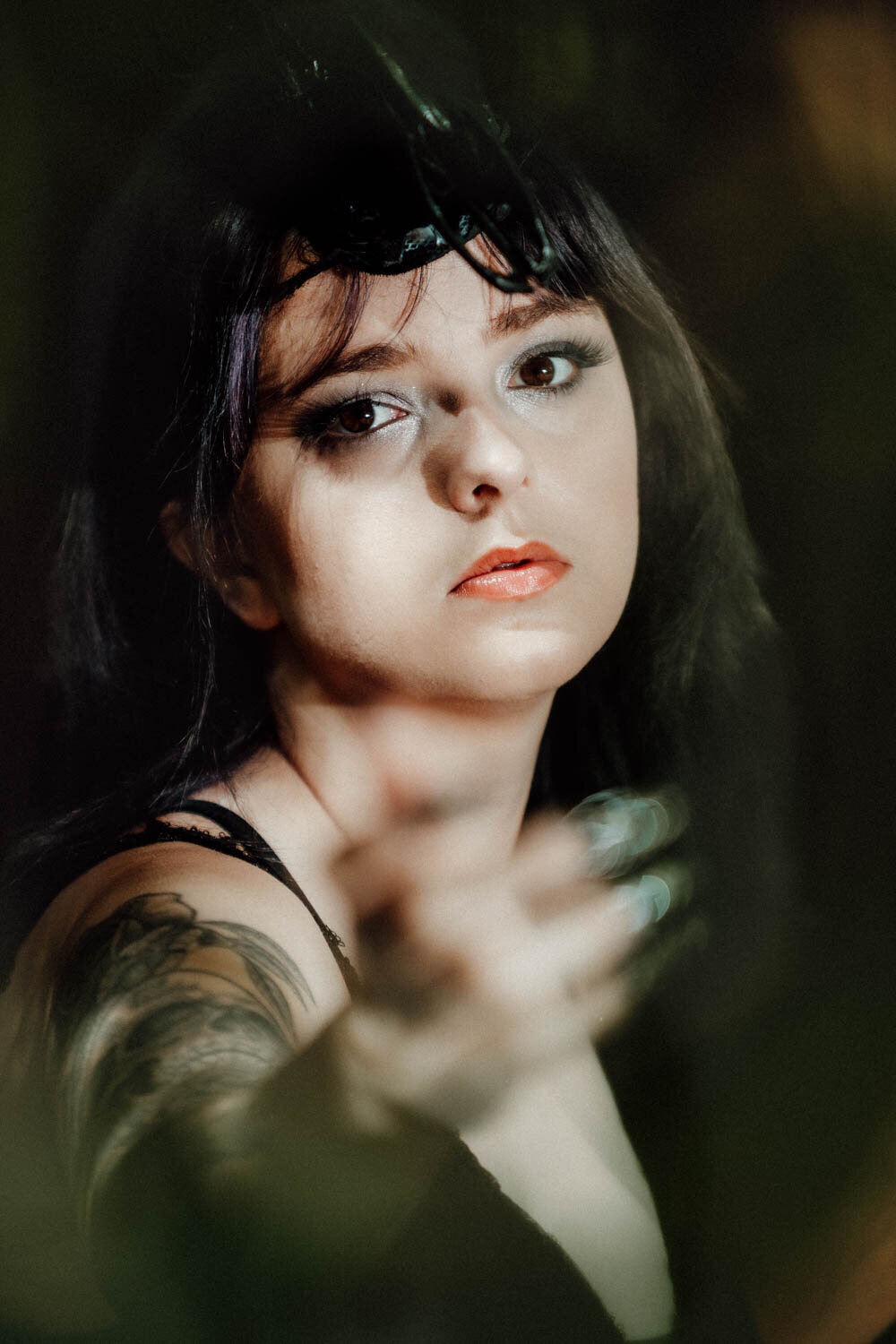Senior portrait of alternative teen with colorful hair and dramatic lighting in downtown Lansing.

