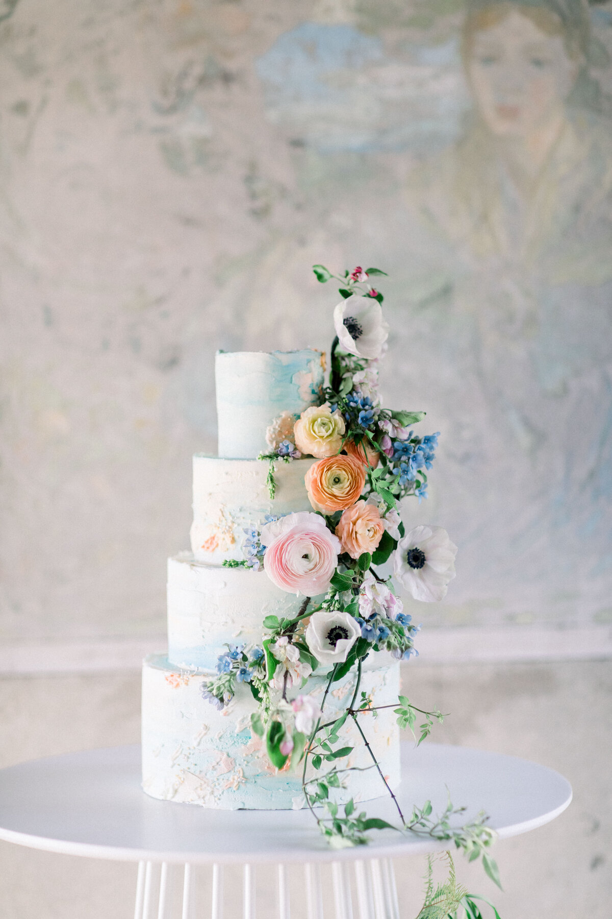 4 tiered wedding cake with florals