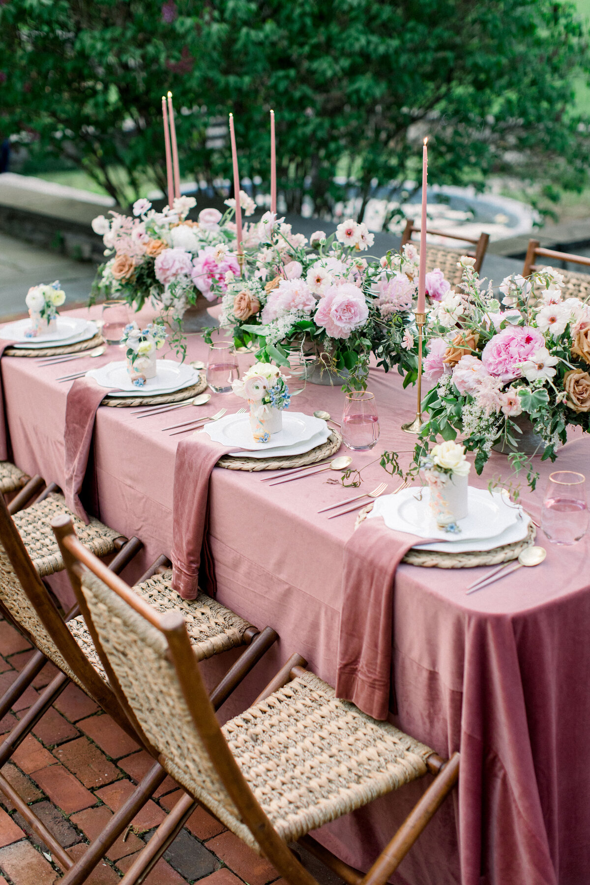 wedding rable with pink table cloth and naptkins with pin florals and candles