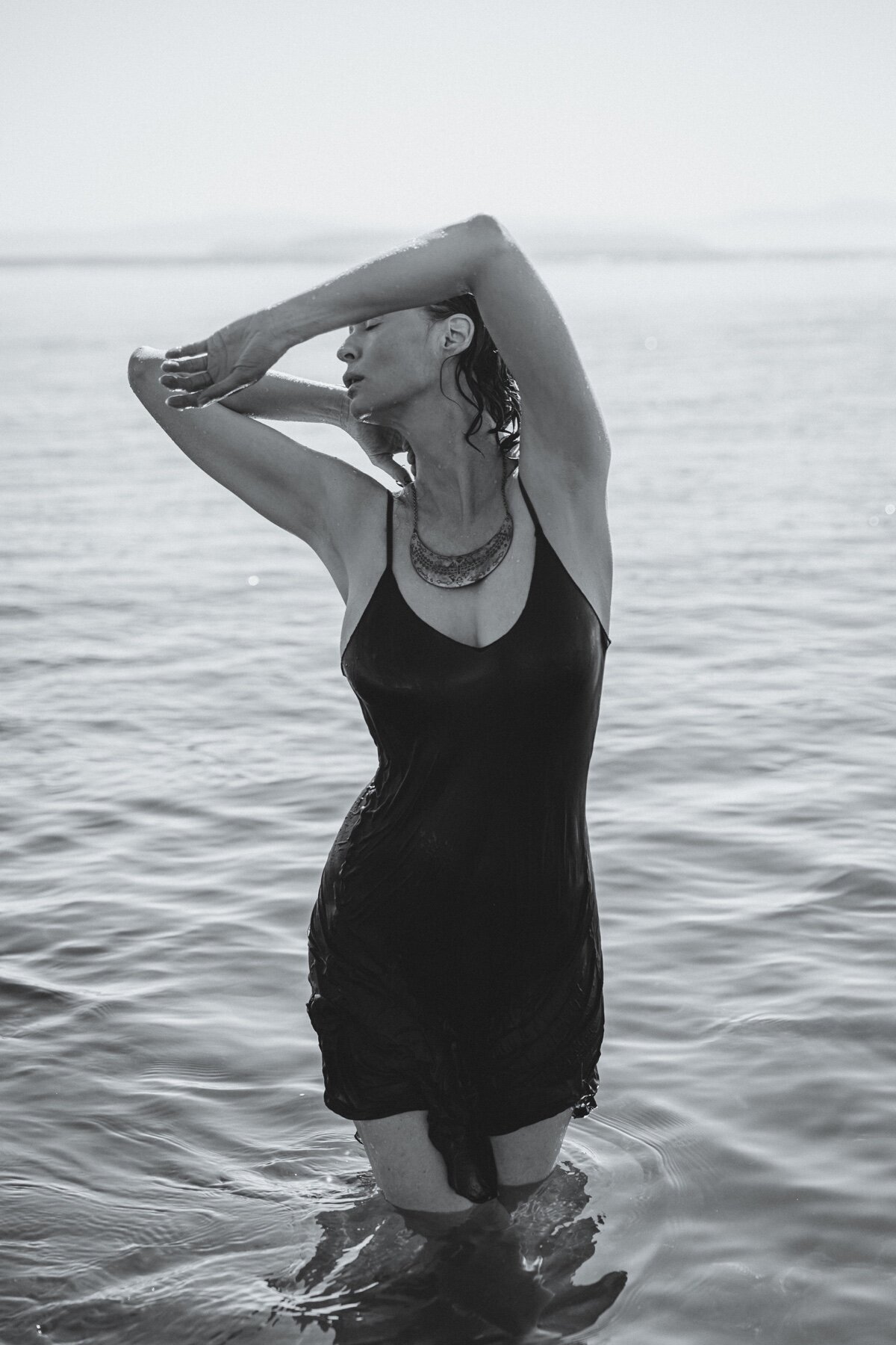Picture of woman coming out of the water in slip dress