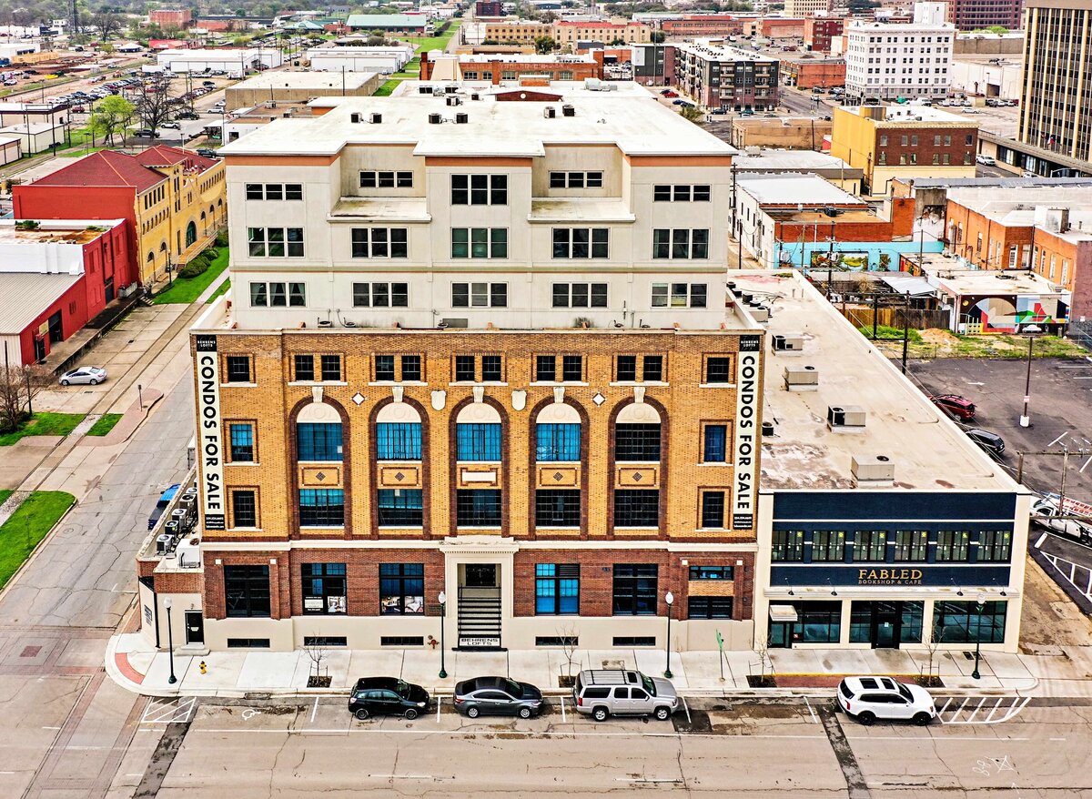 Aerial view of the Behrens Lofts building, which holds this one-bedroom, one-bathroom vintage industrial condo with Smart TV, free Wi-Fi, and washer/dryer located in downtown Waco, TX.