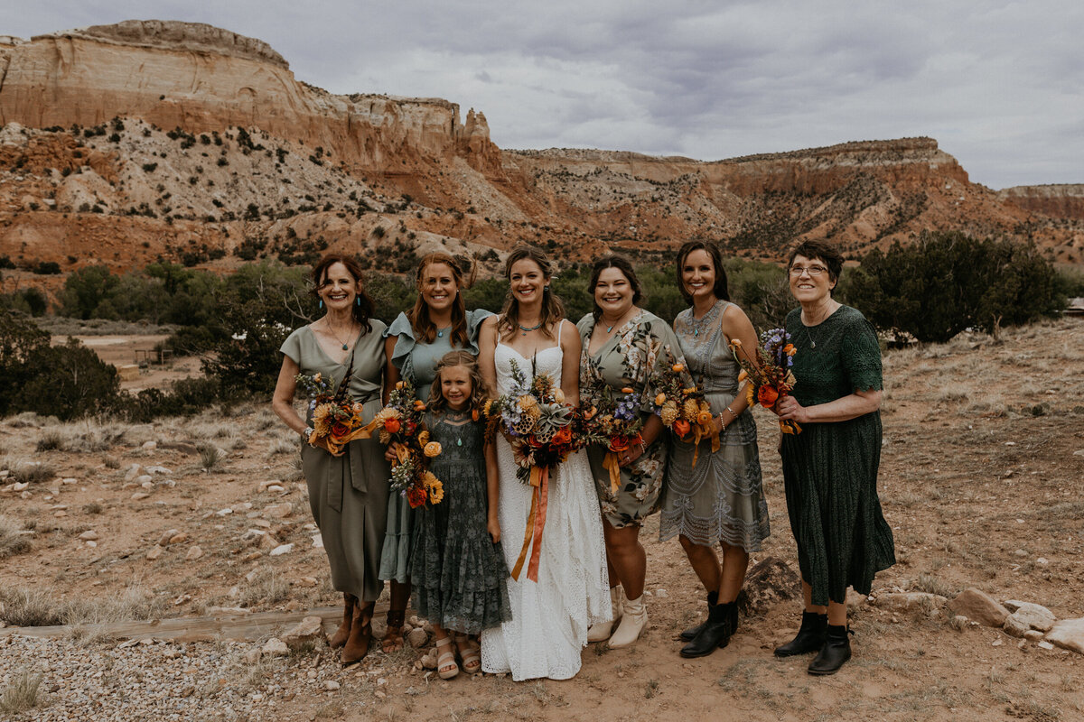 bride and bridesmaids in front of red rocks