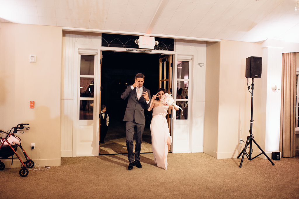 Wedding Photograph Of Groomsman And Bridesmaid Entering The Reception Hall Los Angeles