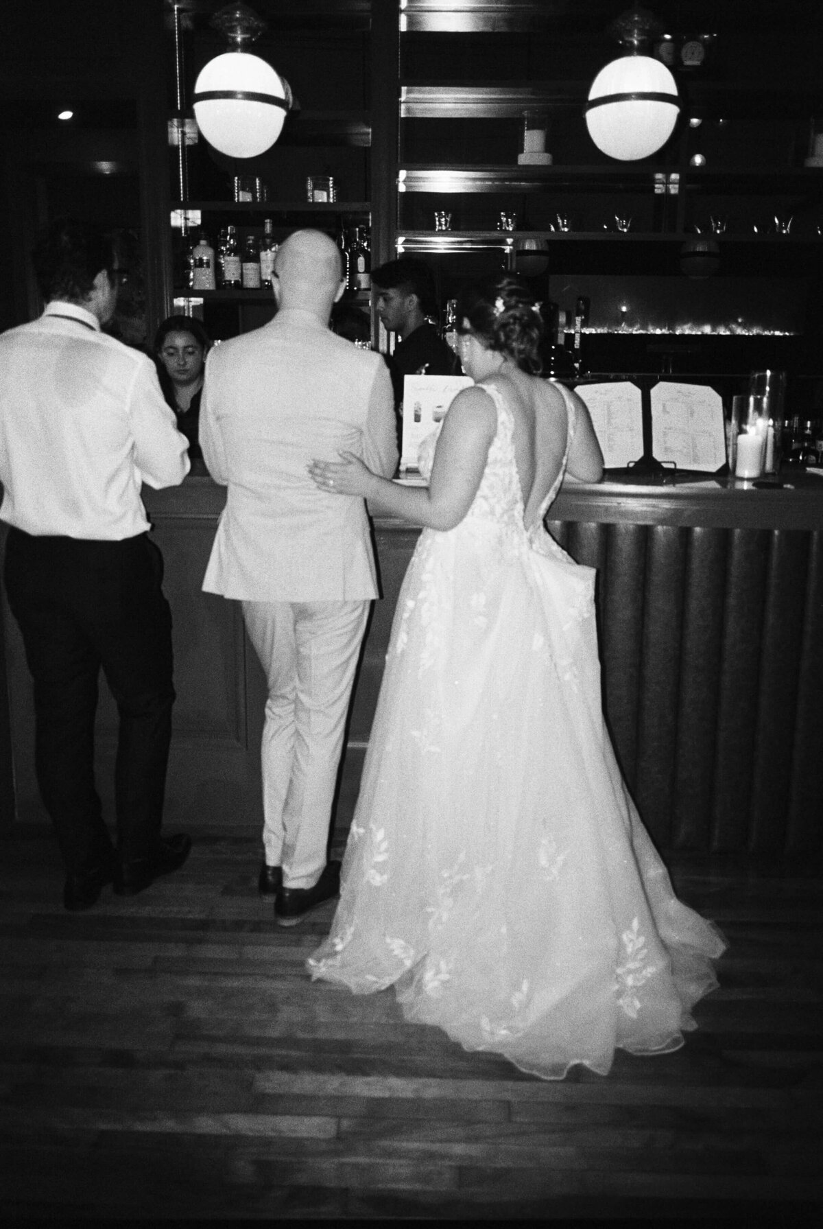 Bride and groom standing at bar at  at Halifax Club wedding in Nova Scotia