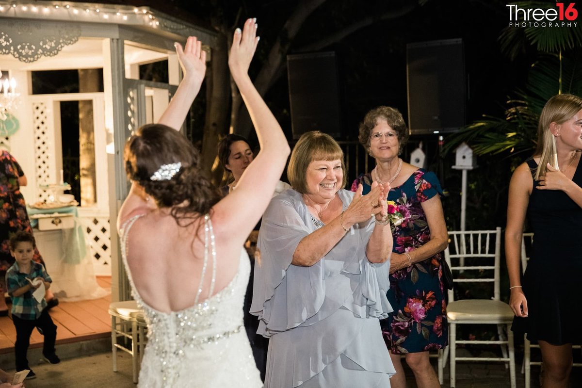 Mom dances with her daughter the Bride