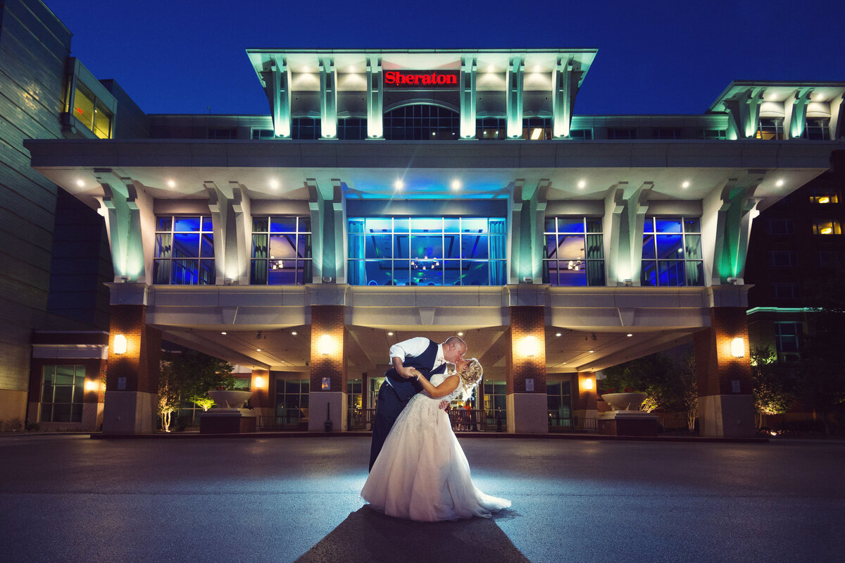 Bride and Groom kissing in front of Sheraton Erie Bayfront.