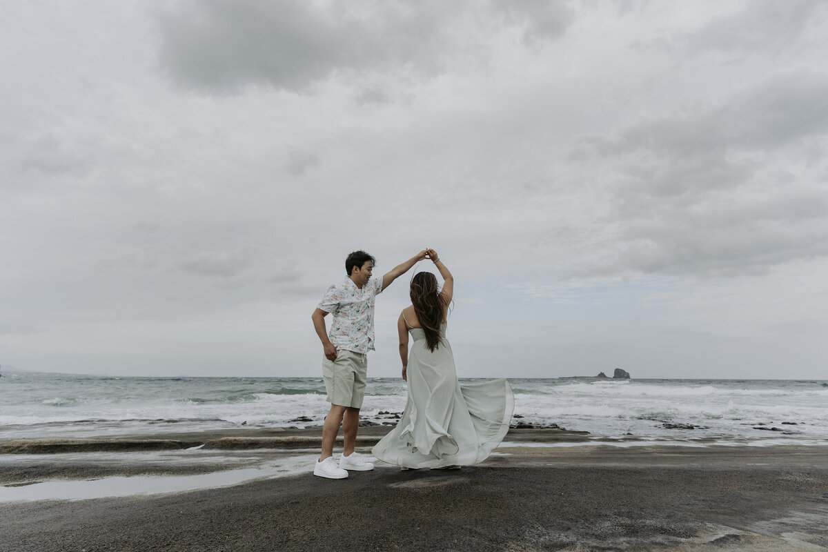 the groom twirls the bride for a dance in Gwangchigi Beach