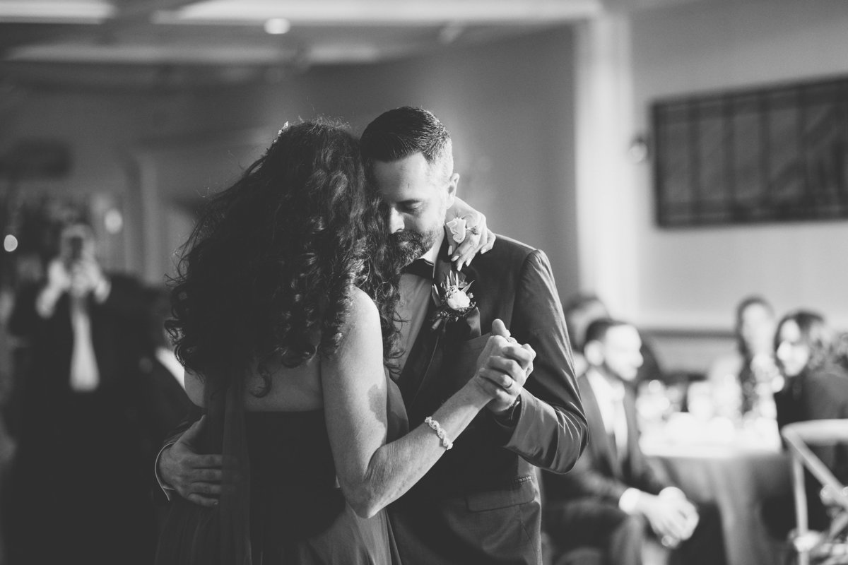black and white photo of groom dancing with mom from wedding reception at The Vineyards at Aquebogue