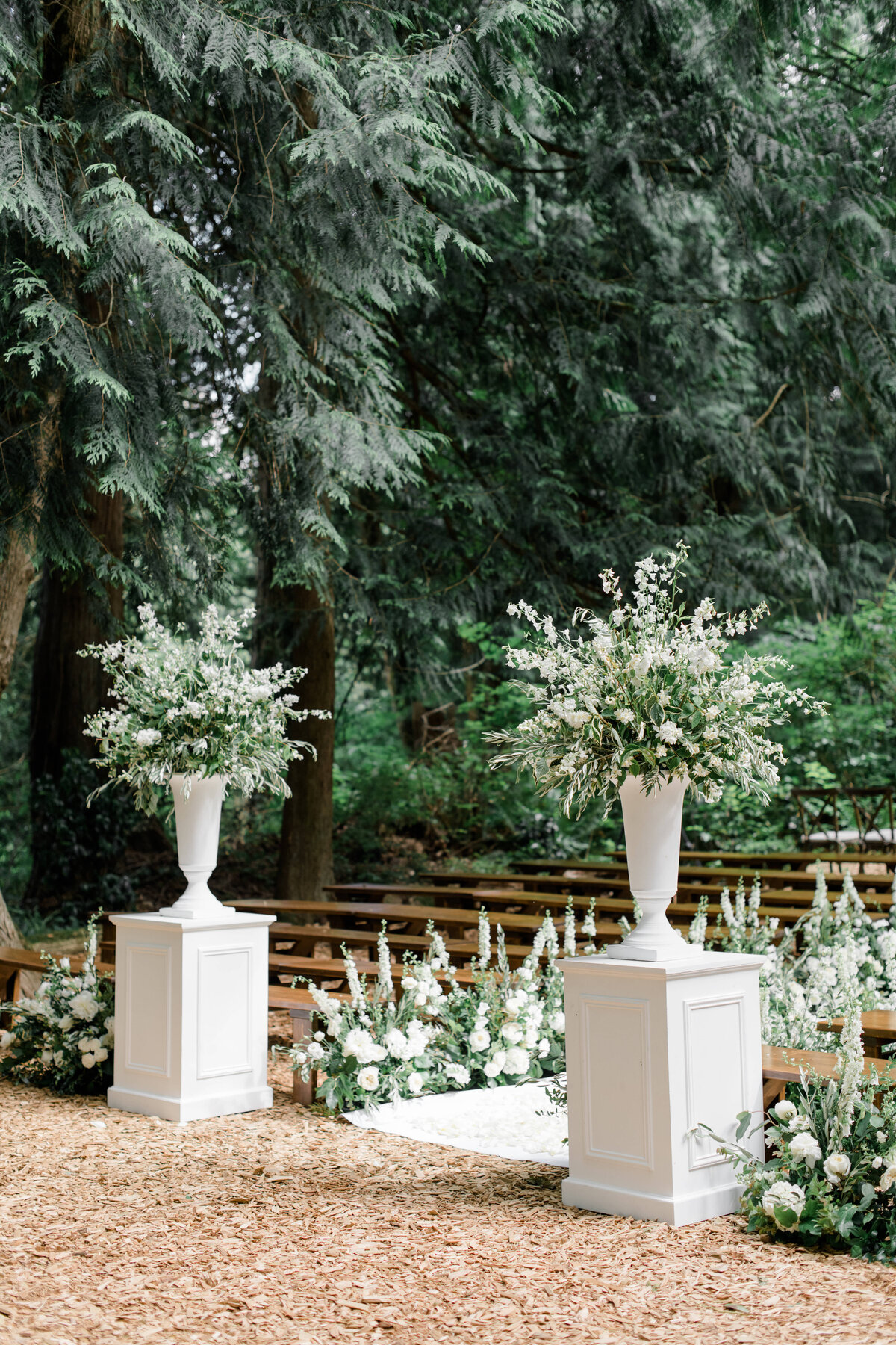 Stunning outdoor wedding ceremony set up with floral lined aisle