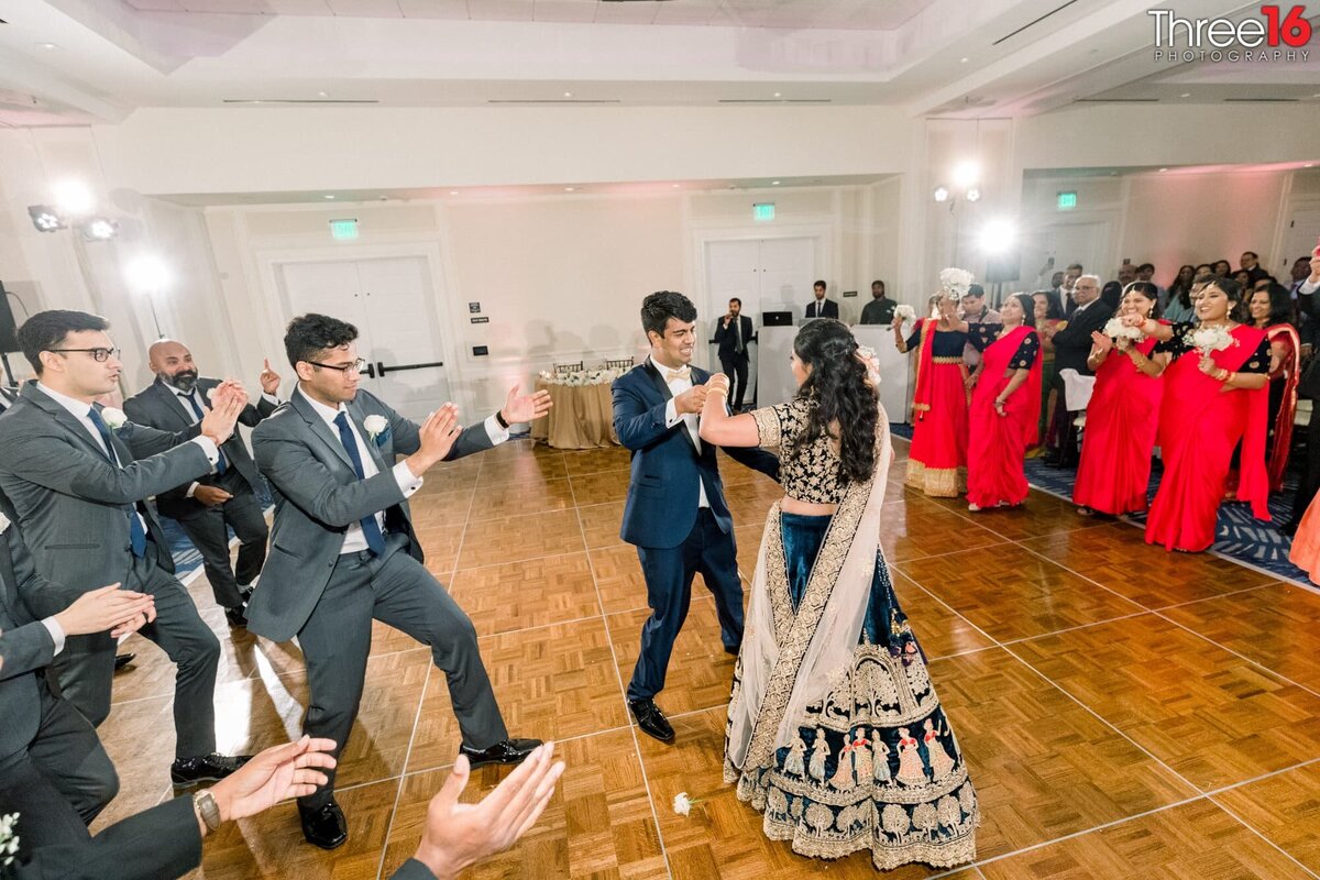 Wedding guests cheer as the Bride and Groom dance their first dance