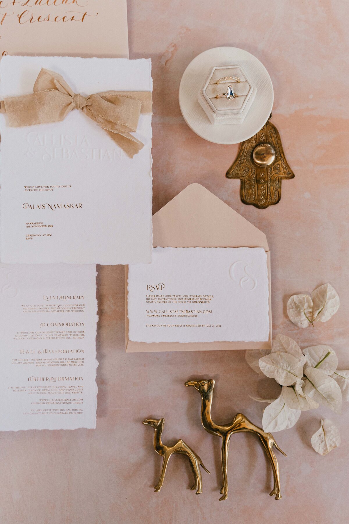 Neutral wedding flat lay, stationary, rings and flowers.