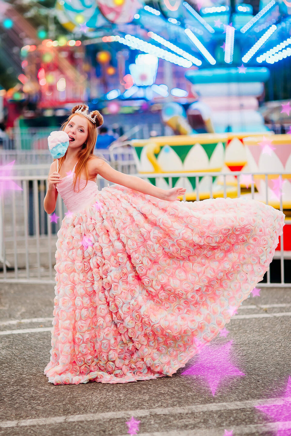 red haired girl earing cotton candy in a pink rainbow dress at a carnival near Annapolis Maryland