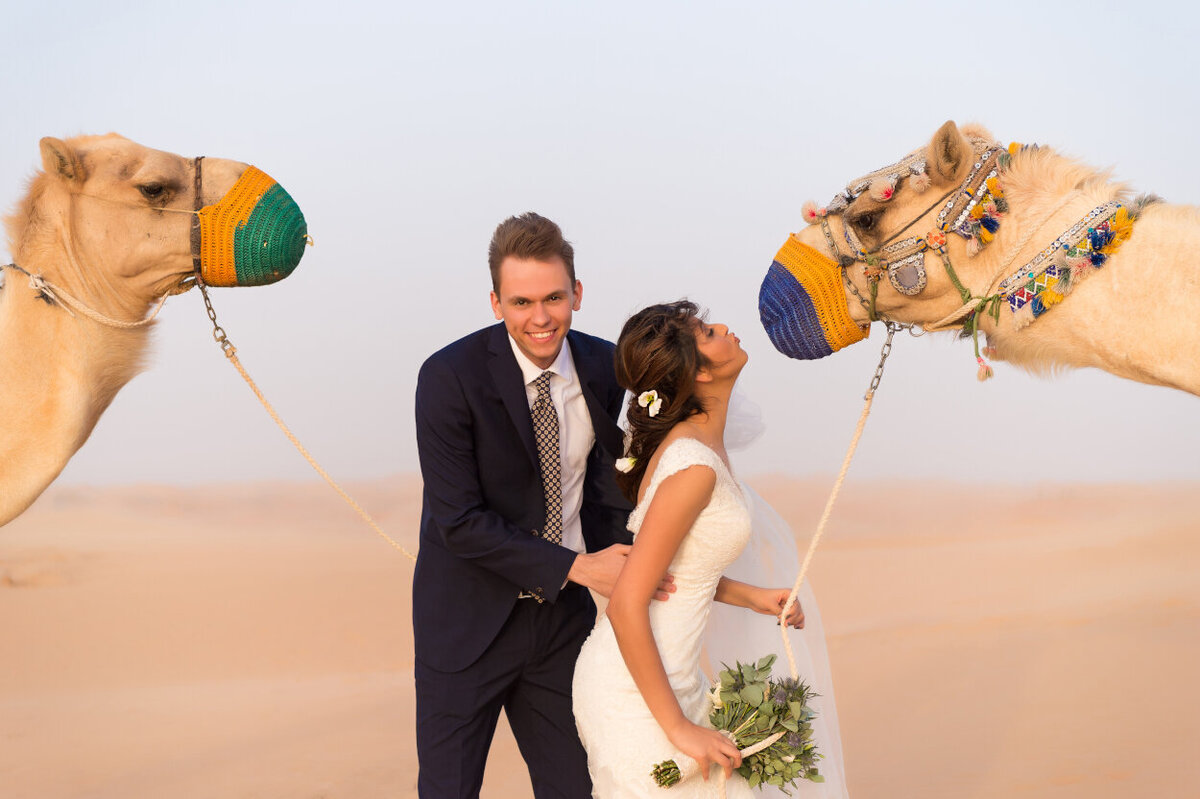 Wedding couple with two camels for a photoshoot in Dubai  organized by Lovely & Planned