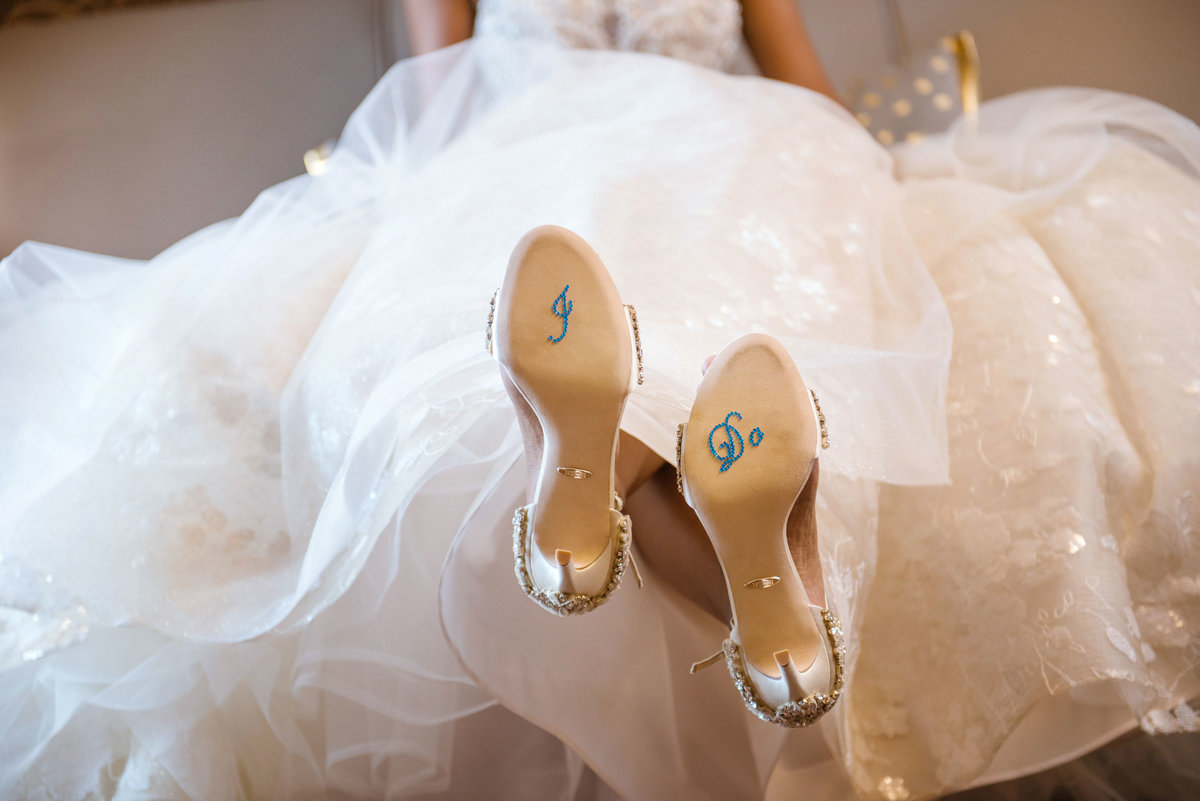 Bride in dress with "I Do" on bottom of shoes The Inn at Fox Hollow