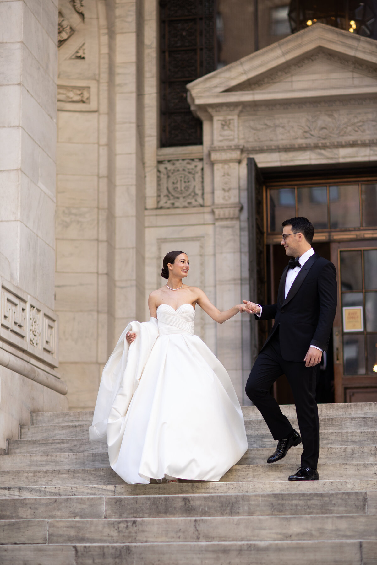 Bride and groom on the steps of NYC public library