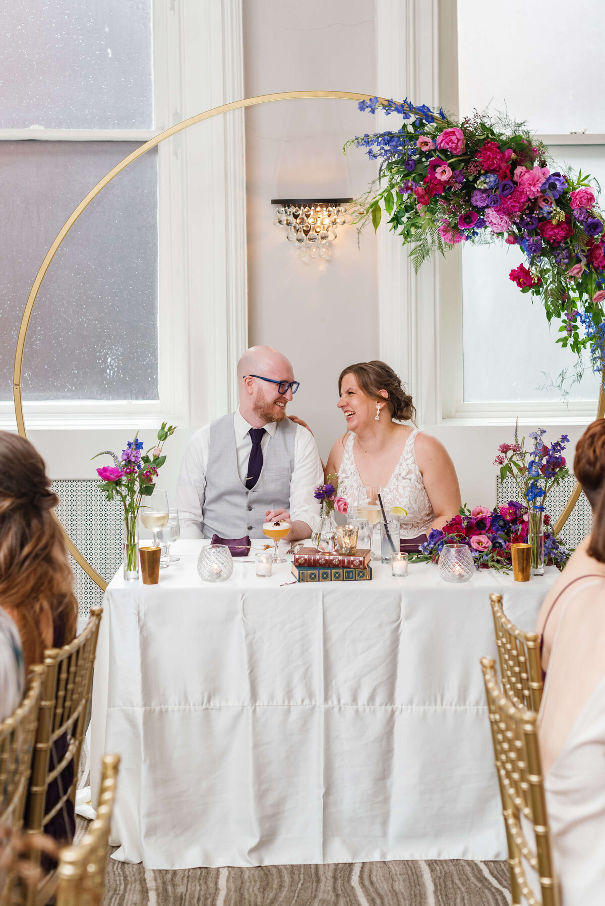 Bride and groom sitting at sweetheart table at  at Halifax Club wedding in Nova Scotia