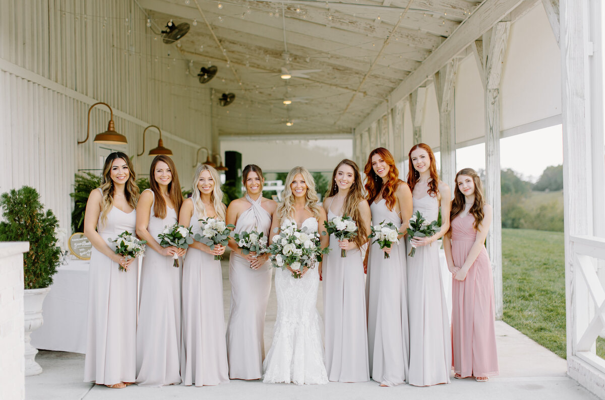 Bride with bridesmaids on patio at White Dove Barn