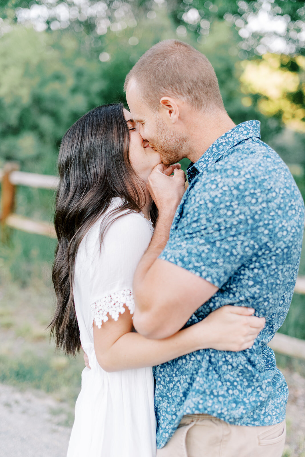 Couple pose pulling her in for a kiss at Sun Valley Engagement Session with the Best Sun Valley Wedding Photographers