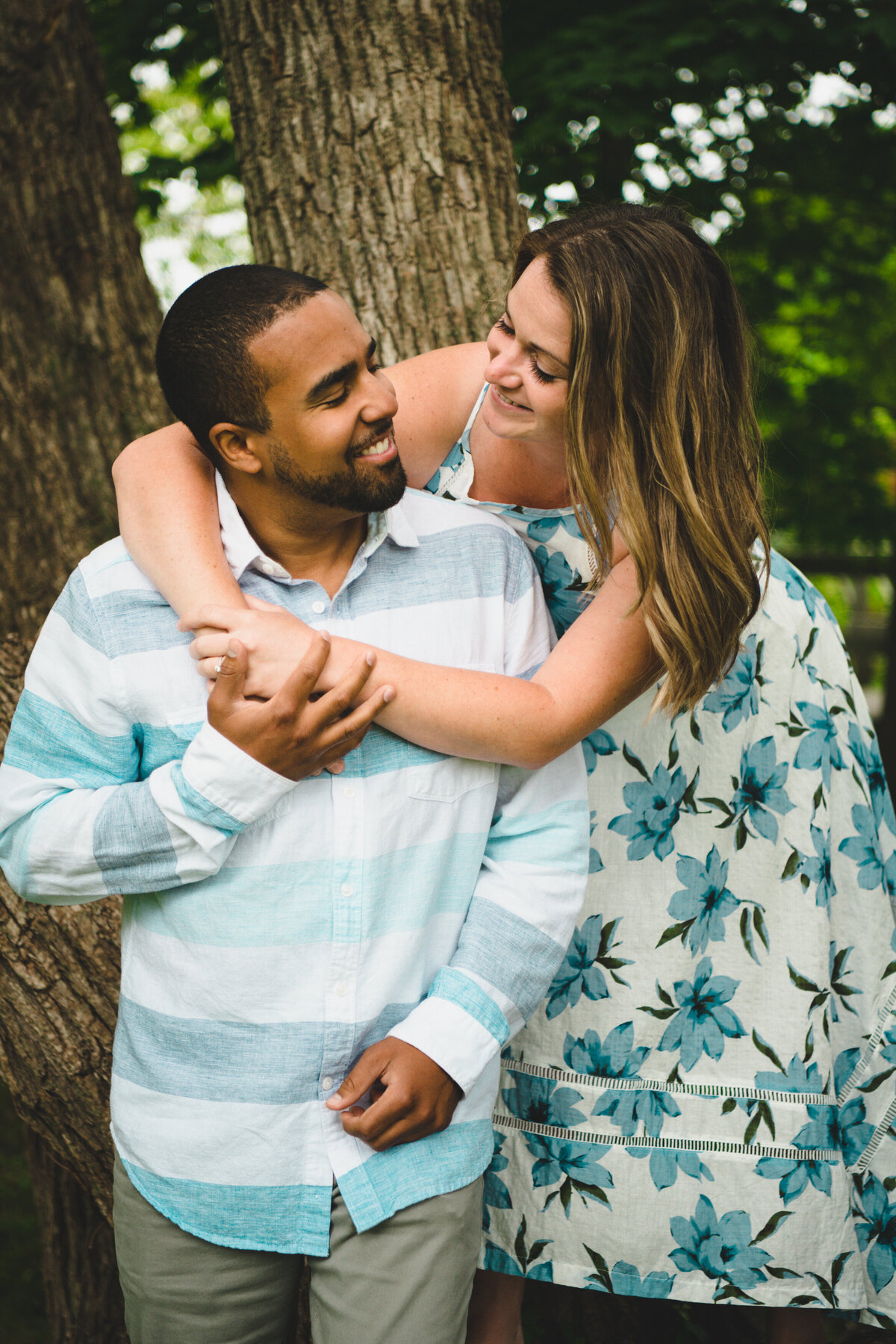 NH engagement photographer with couple hugging
