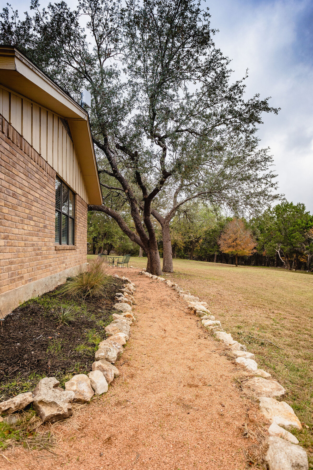 Side view of house with walking path at this three-bedroom, two-bathroom ranch house for 7 with incredible hiking, wildlife and views.
