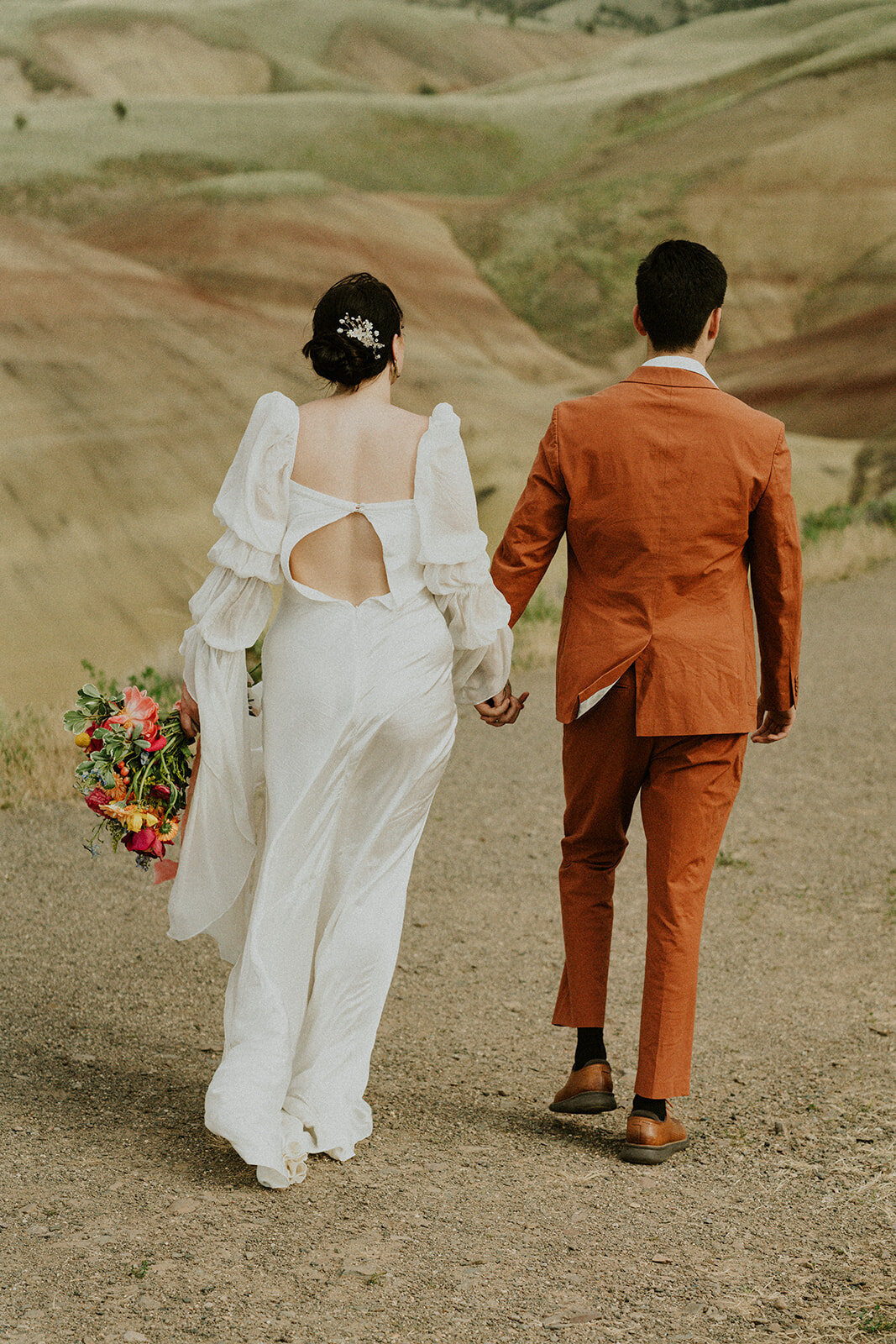 the-bride-and-the-groom-walk-hand-in-hand