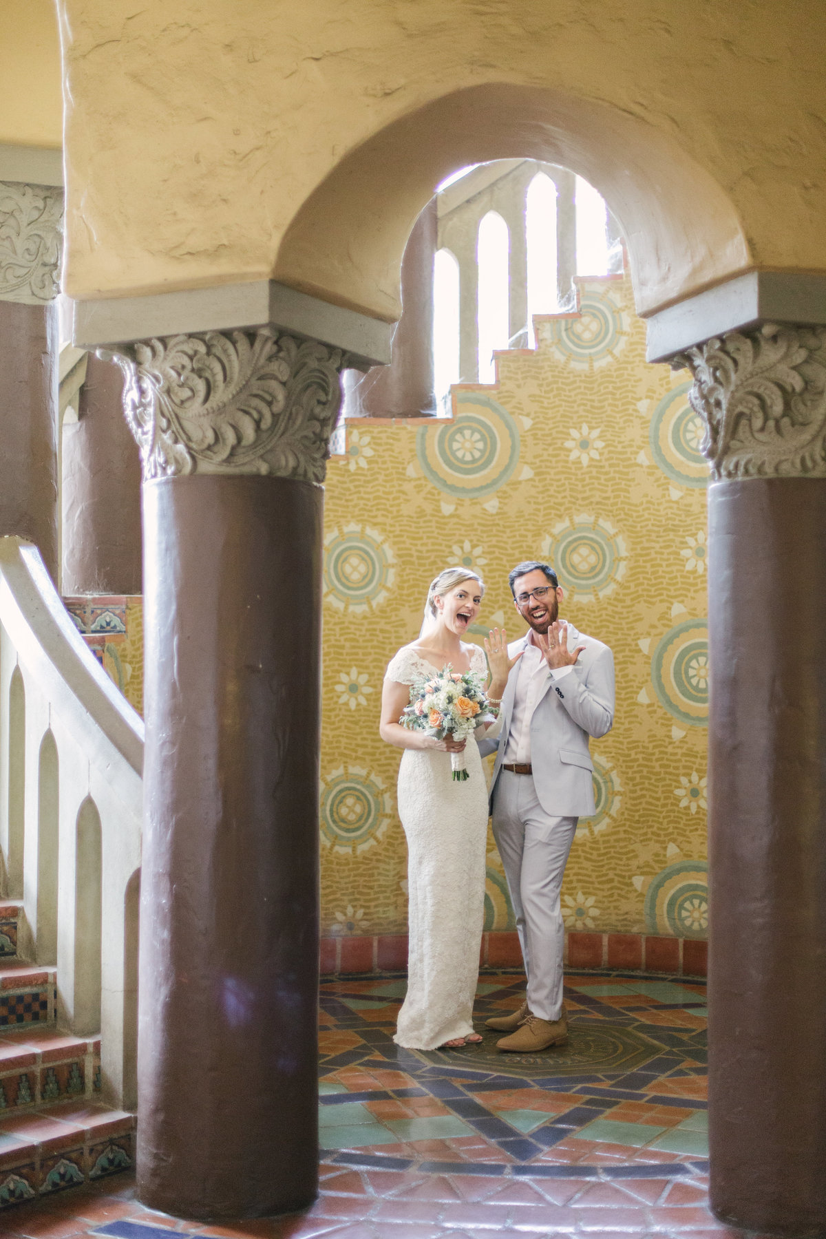 Bride and groom show off their rings at Santa Barbara Courthouse wedding