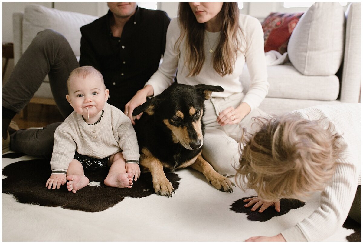 Baby sitting on the floor with dog and toddler at sweet home family session in Austin by Amber Vickey Photography