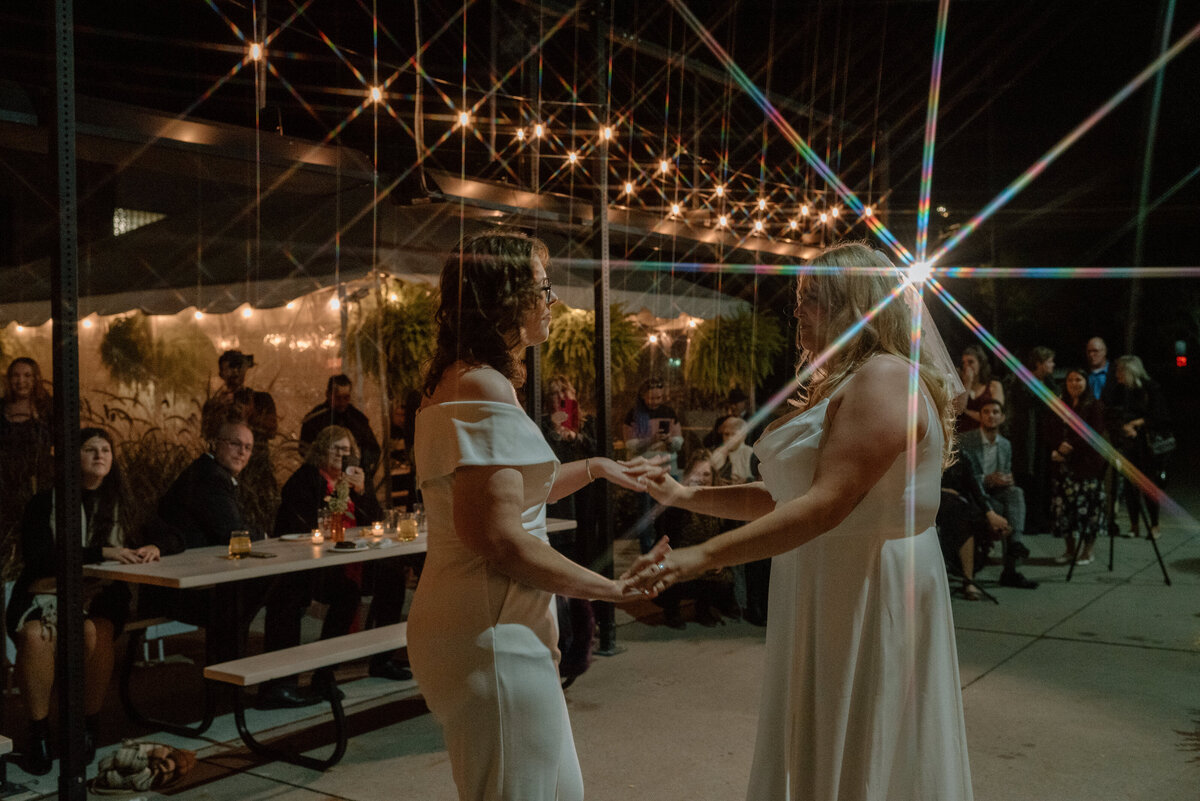 brides have a first dance with fun lighting
