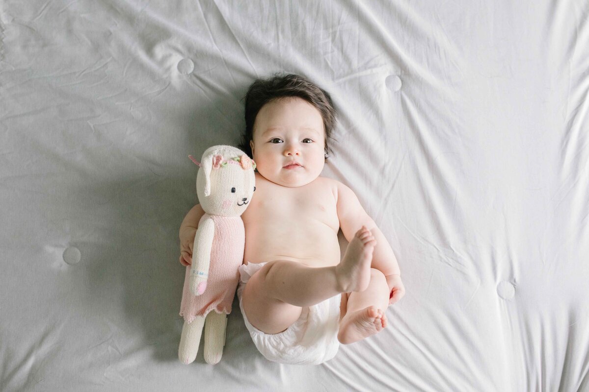 3 month old baby laying on back being photographed in northern virginia