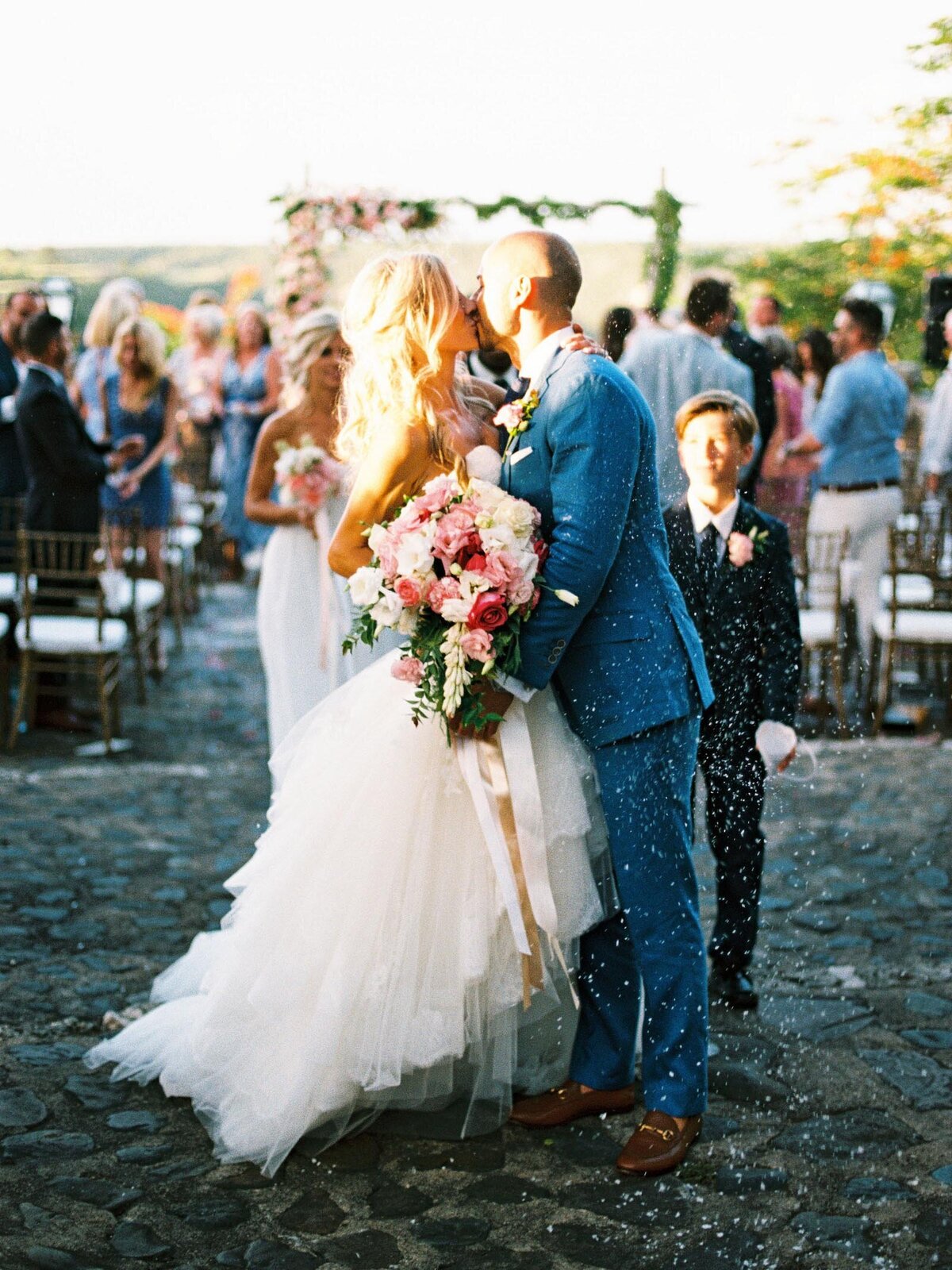 Couple kissing at a beach destination wedding